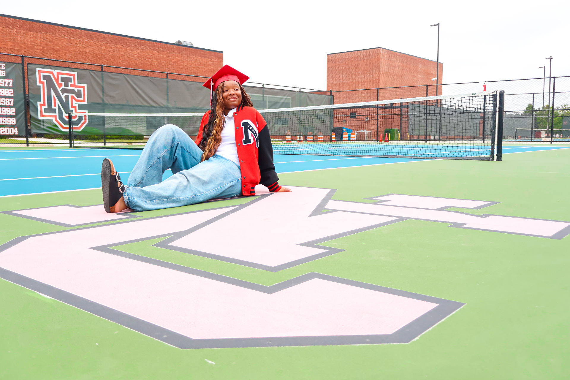 Senior seated on NC tennis court