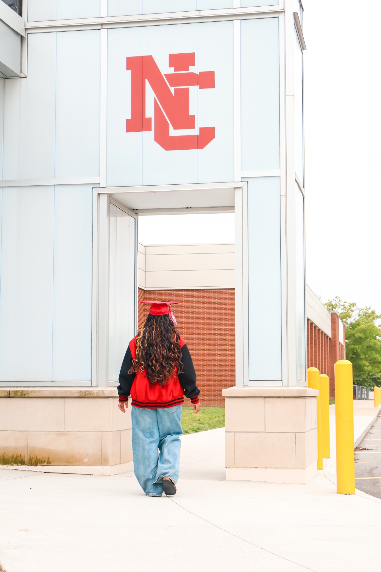 Senior walking under NC logo