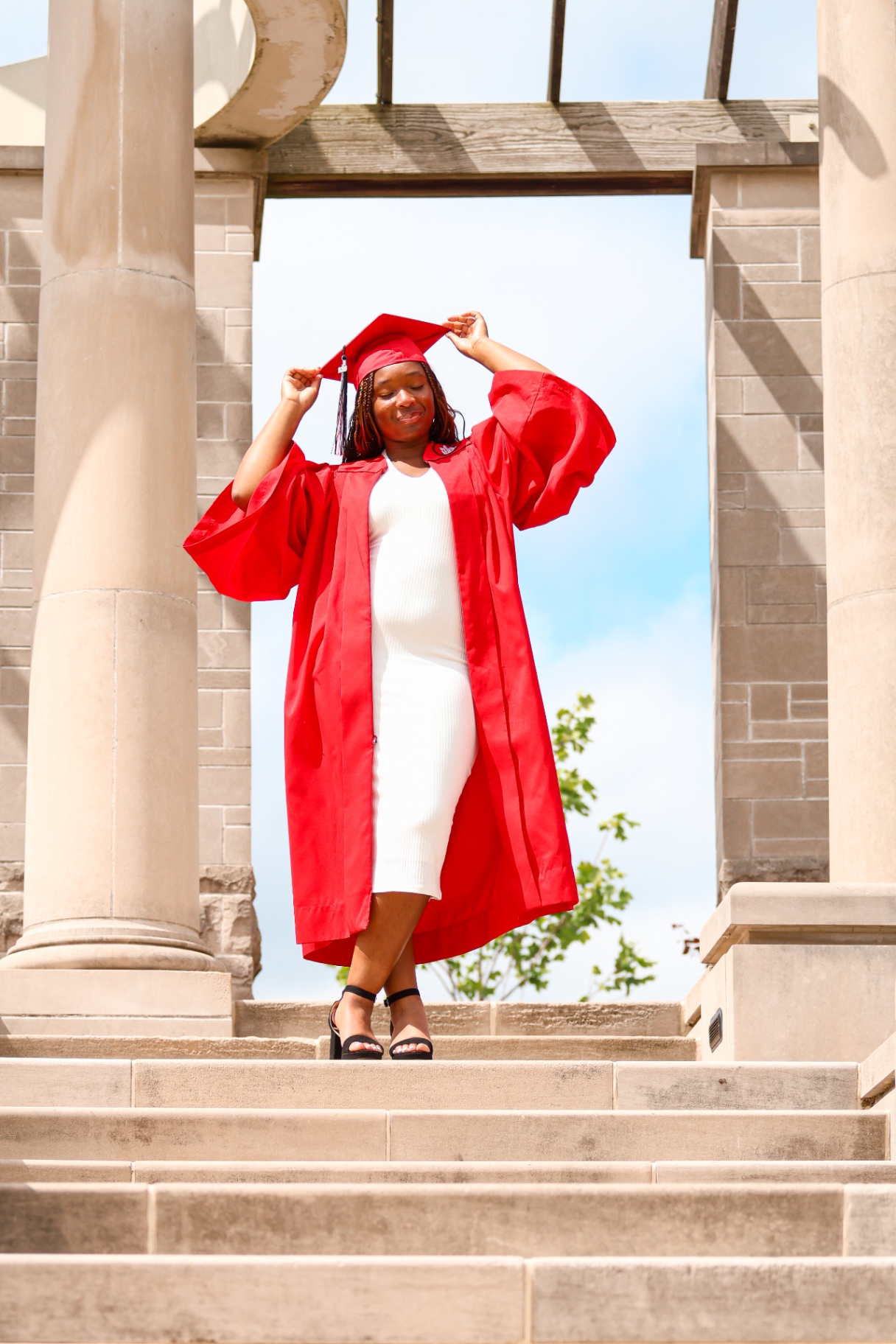 Senior on staircase in red gown