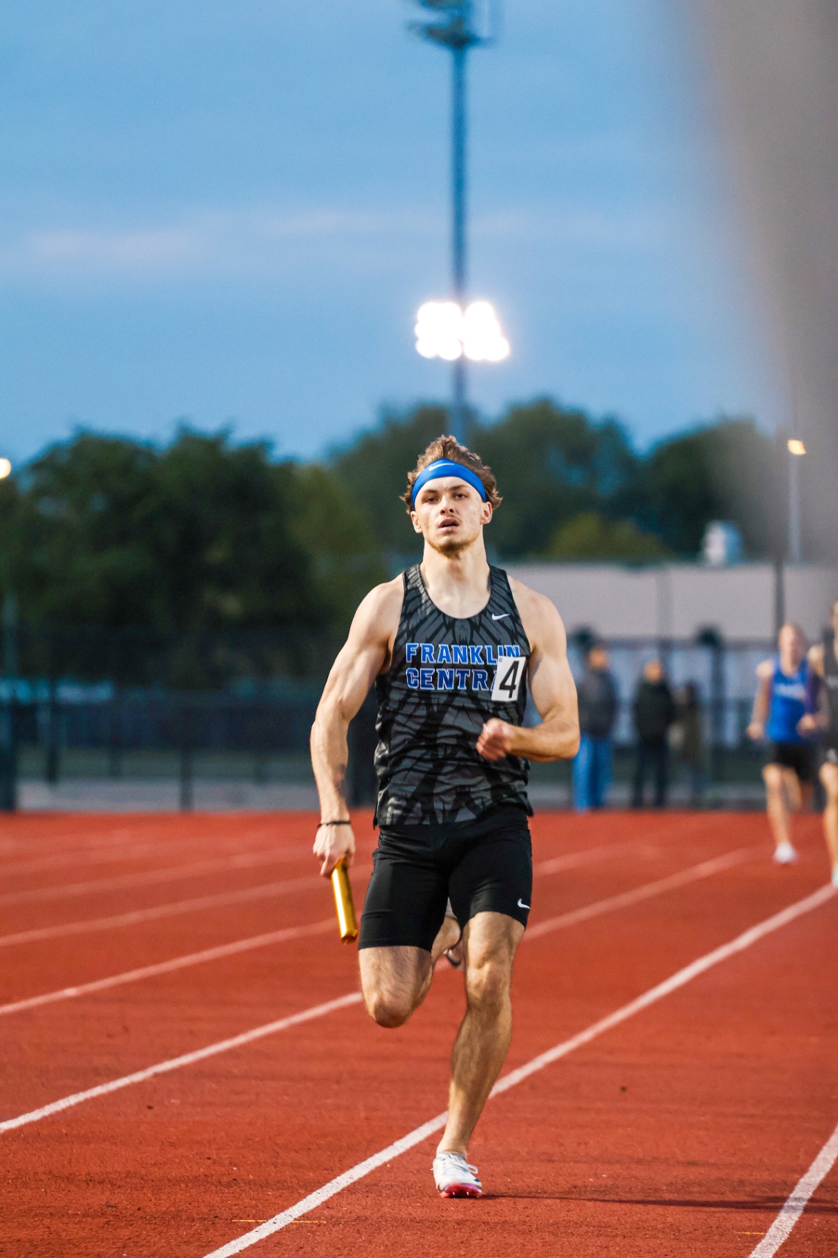 Night track relay runner