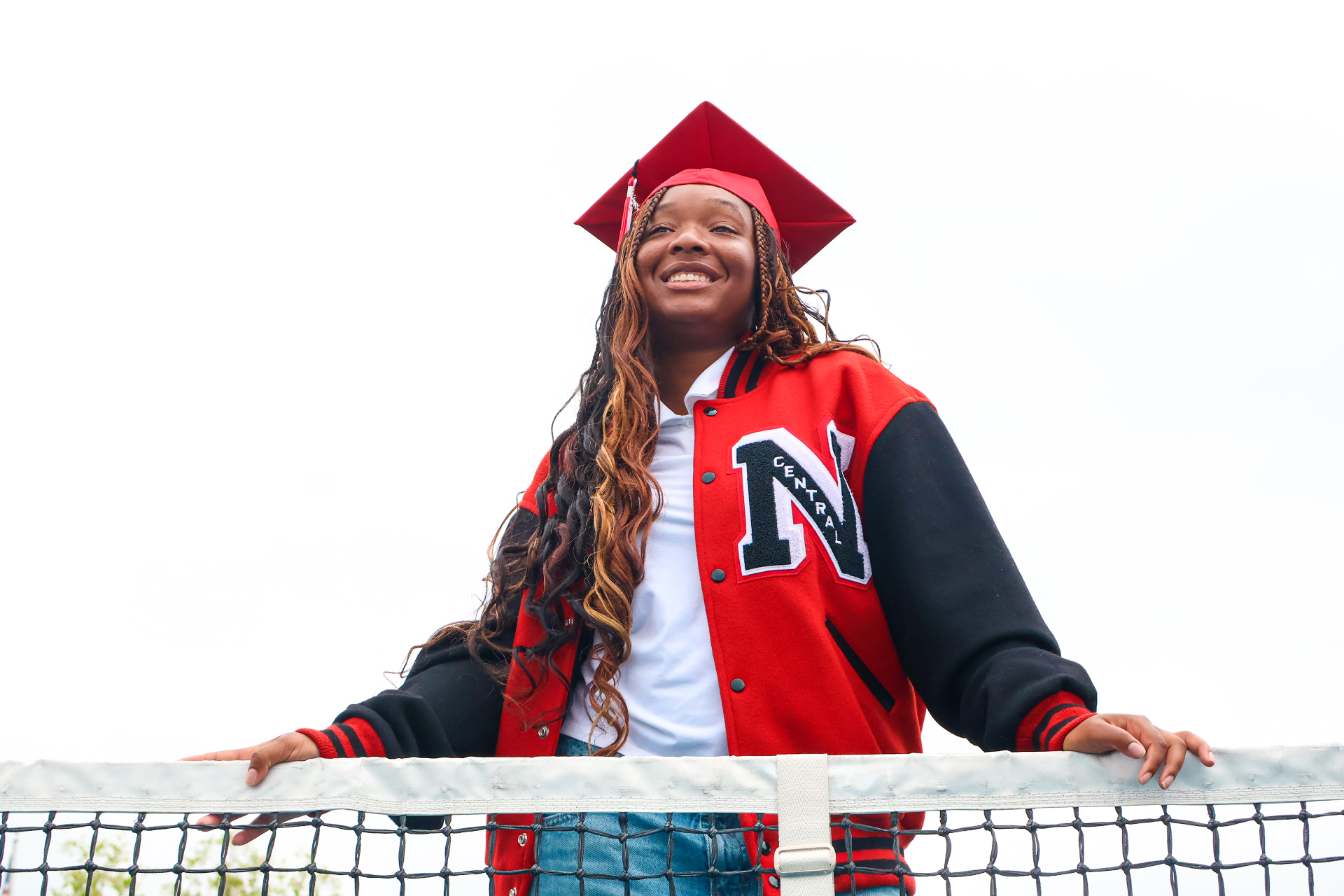 Senior portrait above tennis net