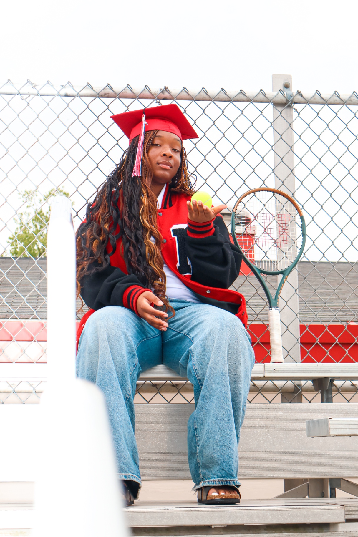 Senior with tennis racket in cap