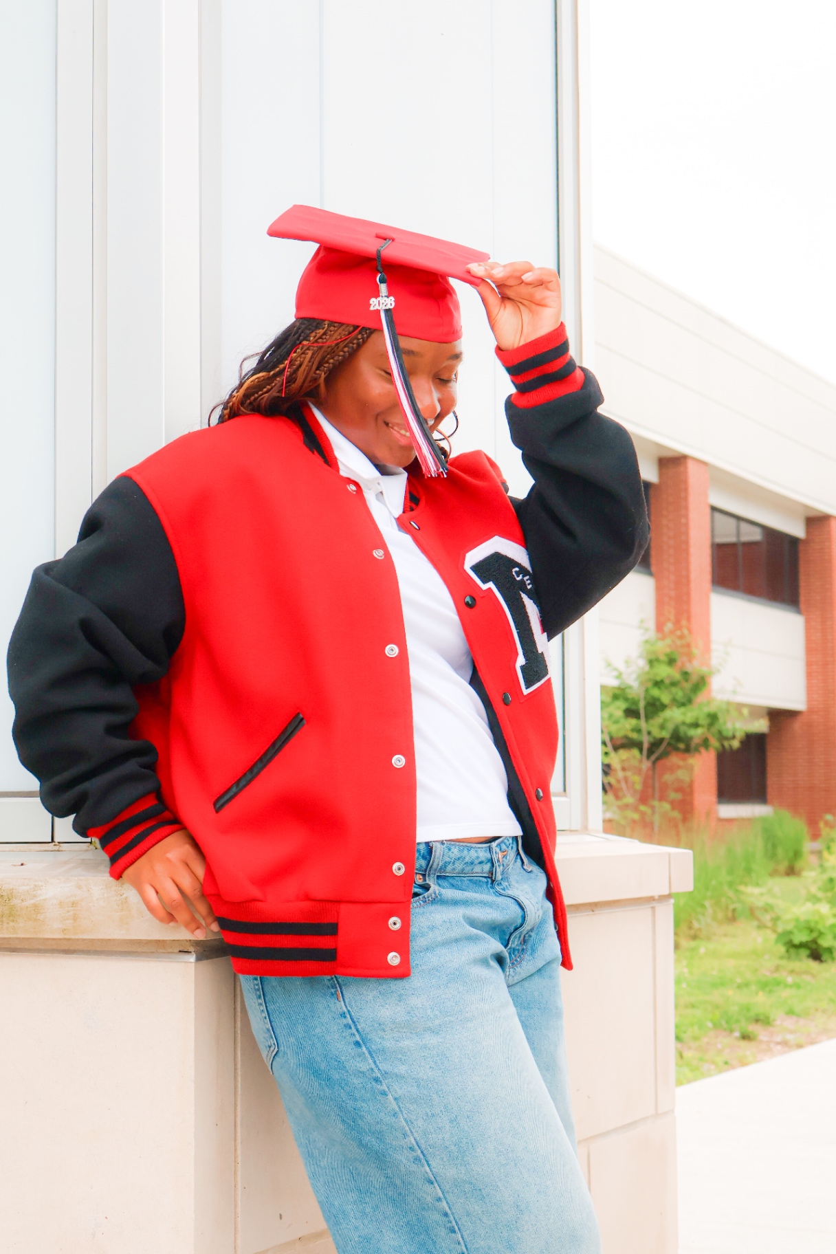 Senior holding red graduation cap