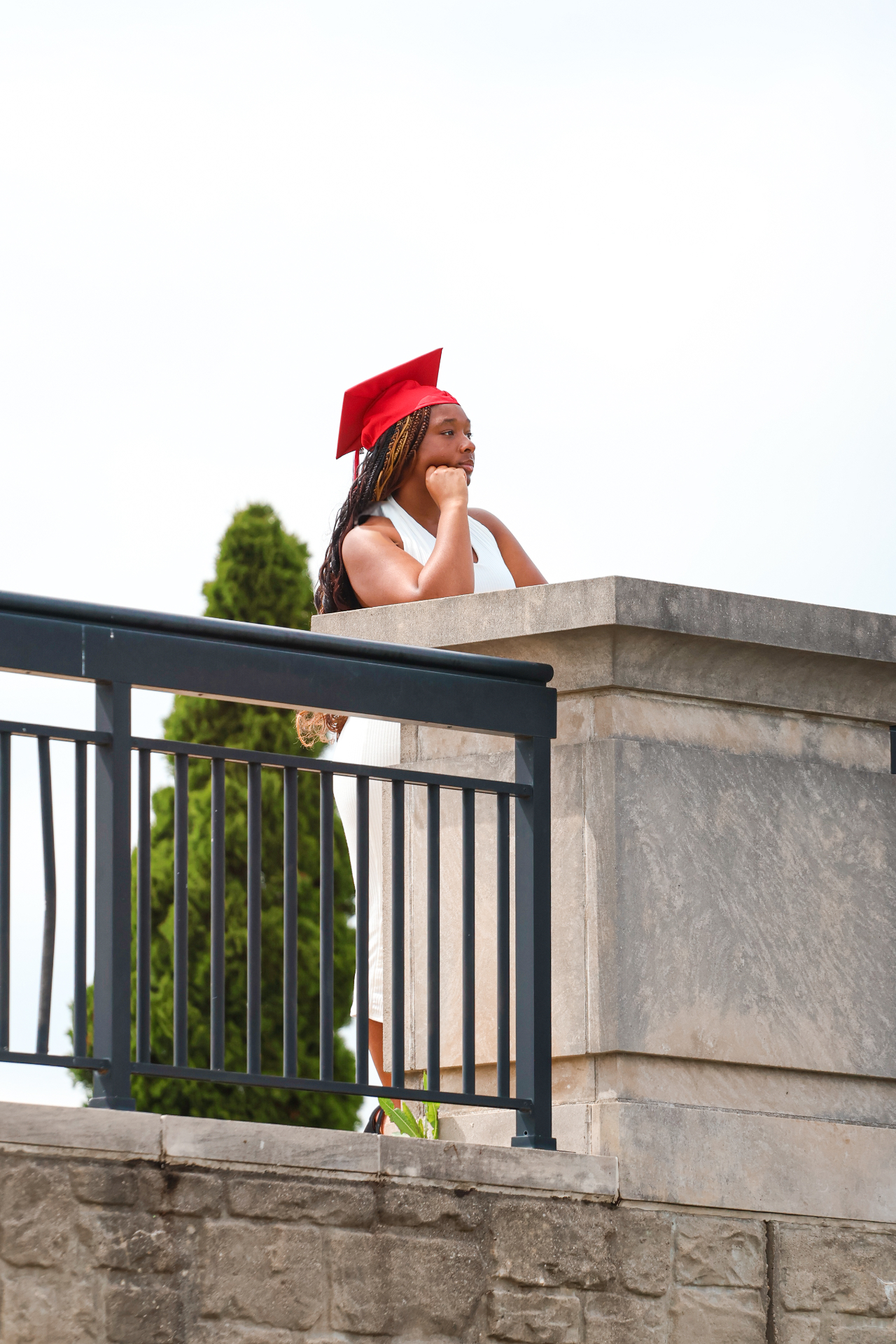 Senior in white dress by stone terrace