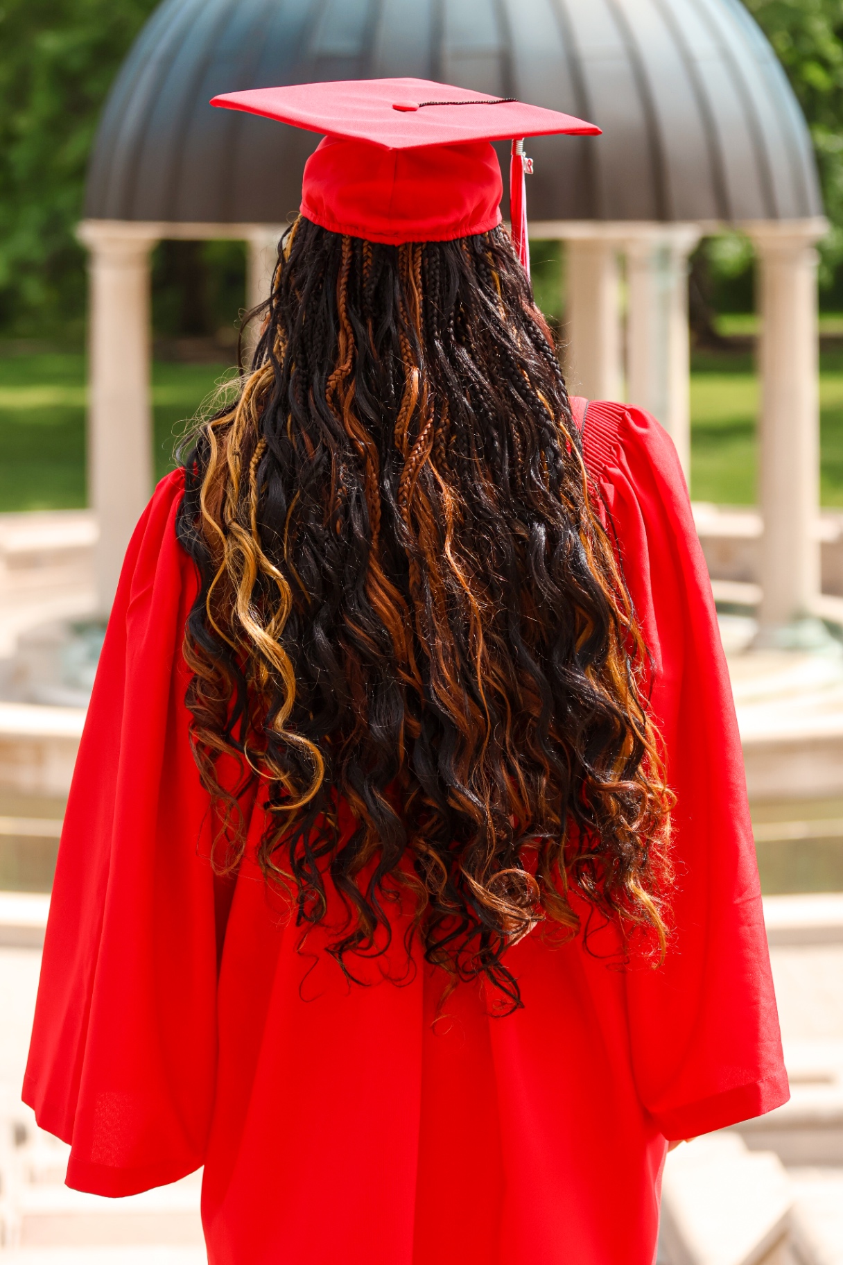 Senior in red gown from behind